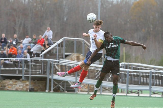 two soccer players going for a header